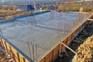 Insulated floor slab installation creating a strong base that helps retain heat and improve comfort year round.